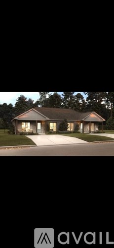 A house with a front yard and a driveway.