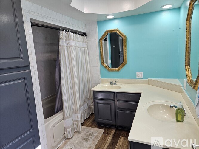A bathroom with a blue wall and a white sink.