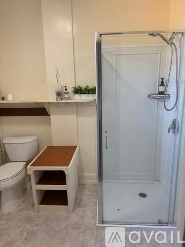 A bathroom with a toilet, sink, and shower.