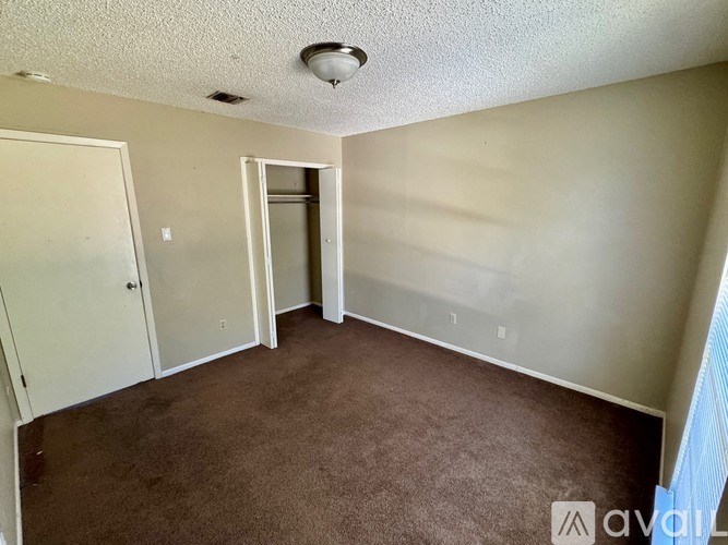 A room with a carpeted floor and a ceiling light.