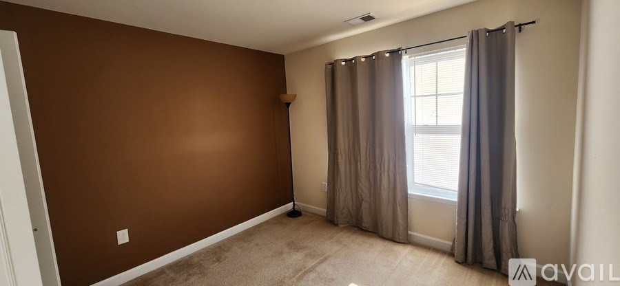 A room with brown walls and a carpeted floor.