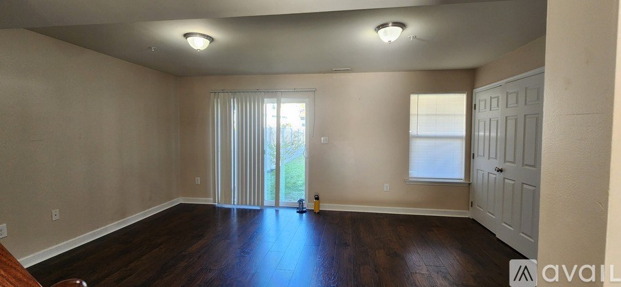 A room with wooden floors and a sliding glass door.