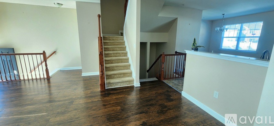 A living room with a staircase leading to the upper floor.