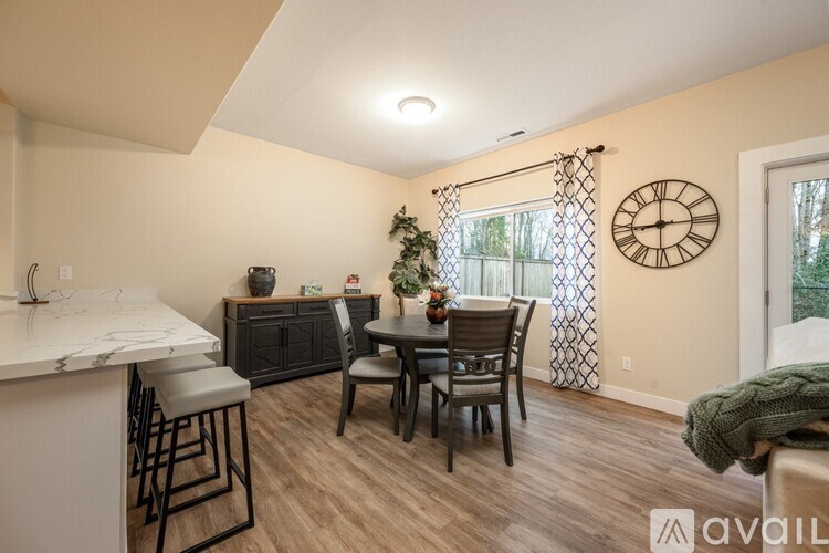 A kitchen with a bar area and a dining table with chairs.
