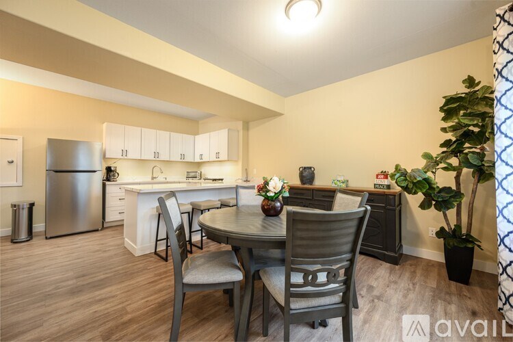 A kitchen with a table and chairs in the middle of the room.