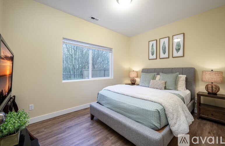 A bedroom with a large bed and a television on the left side.
