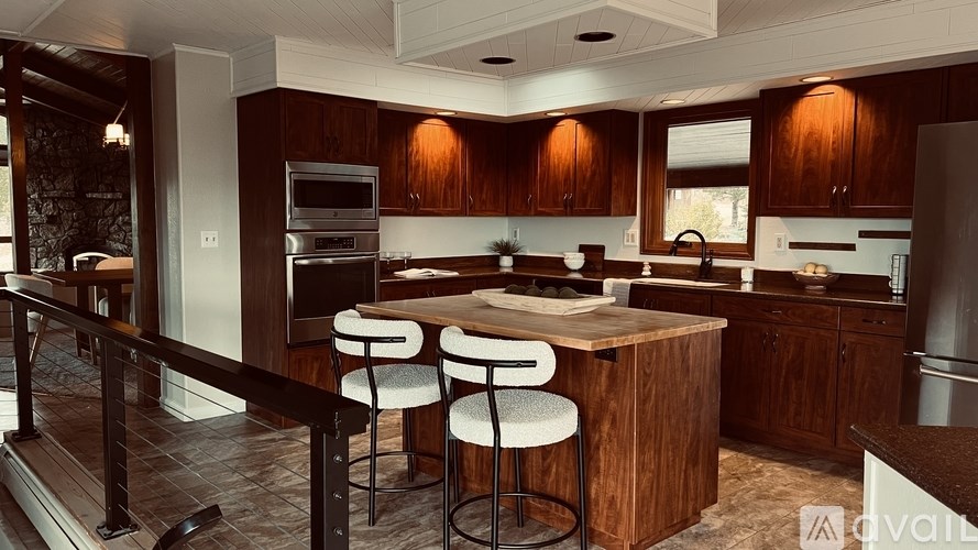 A kitchen with wooden cabinets and a center island.