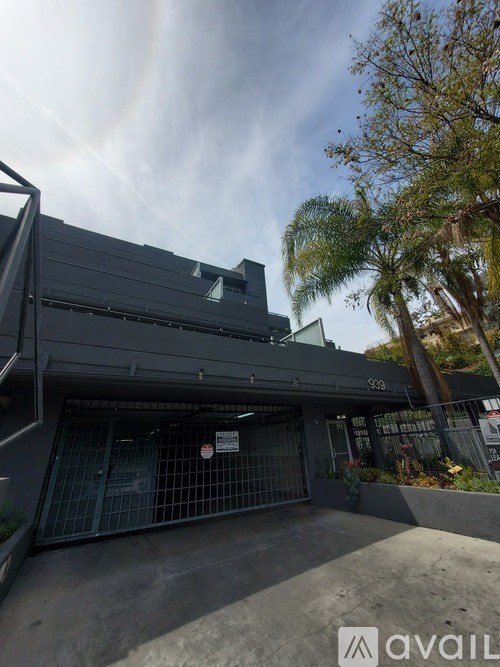A modern building with a glass door entrance and a sign that reads "avail".