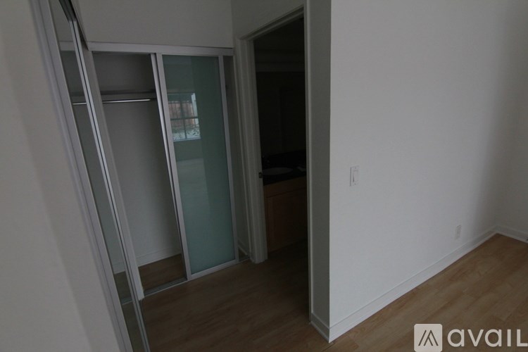 A room with a white wall and a wooden floor.
