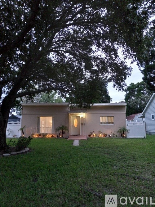 A house with a tree in front of it.