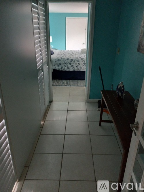 A room with a bed and a chair in it.