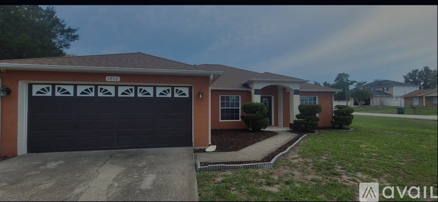 A house with a brown garage door and a driveway.