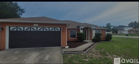 A house with a brown garage door and a driveway.