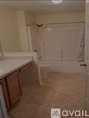 A bathroom with a tub, sink, and toilet.