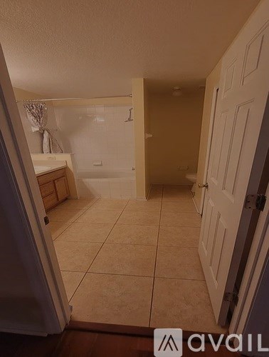 A bathroom with a toilet, sink, and bathtub.