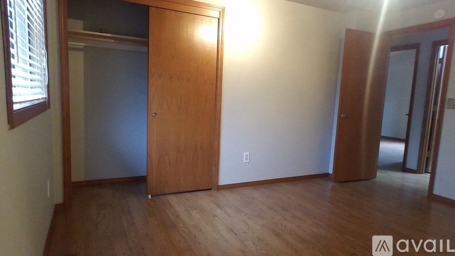 A room with a wooden floor and a wooden door.