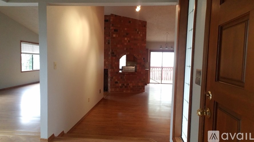 A room with a brick wall and wooden floors.