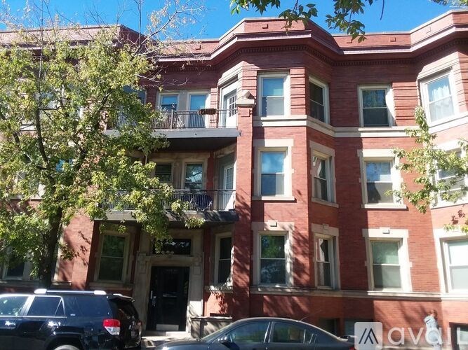 A red building with a balcony on the second floor.