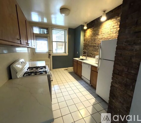 A kitchen with a white stove top oven and a white refrigerator.