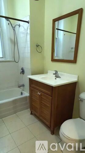 A bathroom with a toilet, sink, and tub.