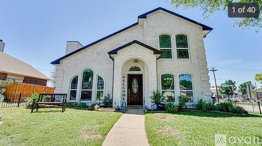 A white church with the word "welcome" written on the front door.