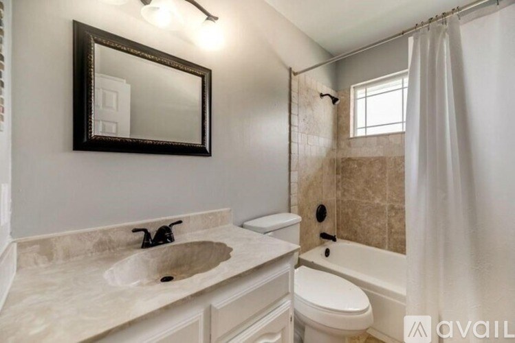 A bathroom with a sink, toilet, and bathtub.