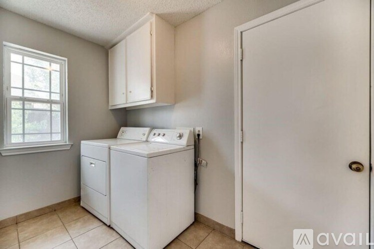A small laundry room with a washer and dryer.