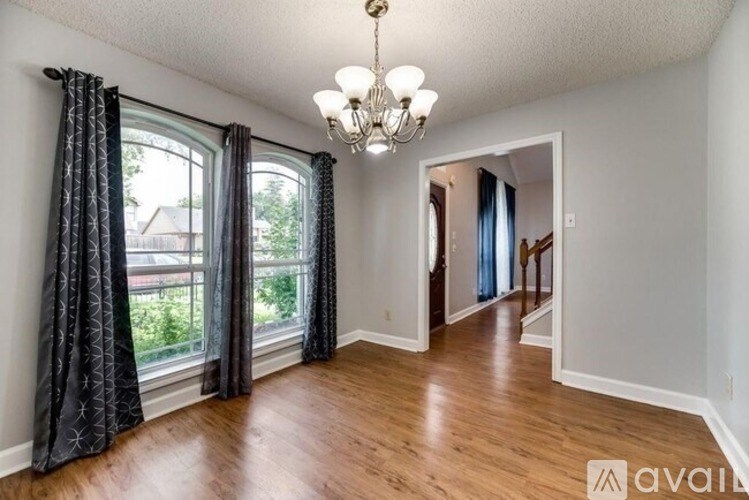 A room with wooden floors and a chandelier.
