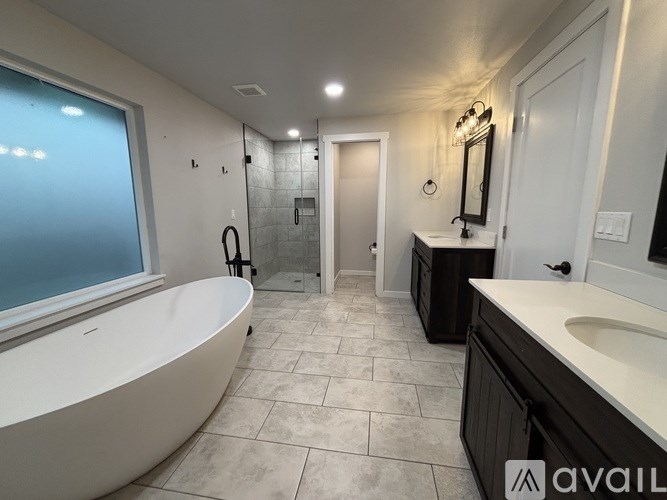 A bathroom with a large tub and a walk-in shower.