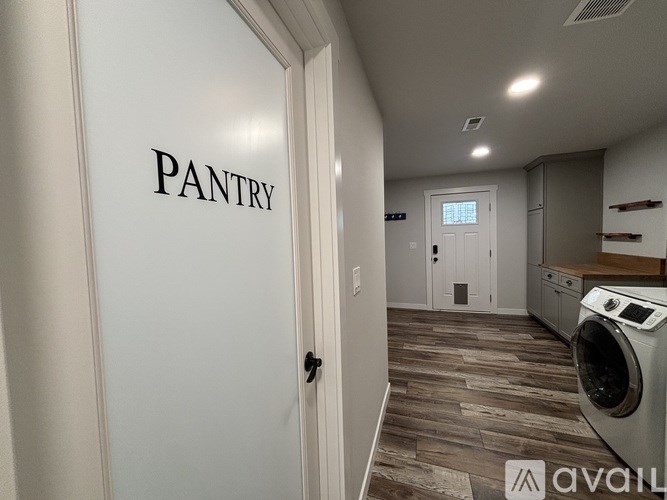 A pantry door is open to a laundry room.