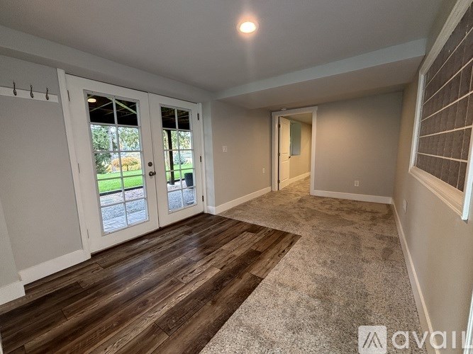 A room with a carpeted floor and a sliding glass door.