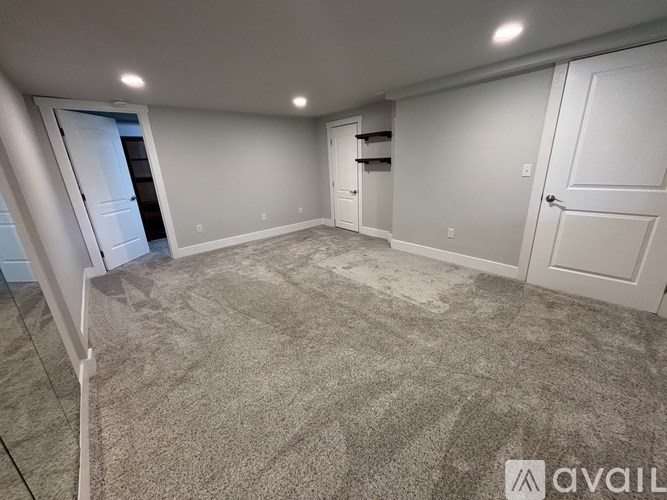 A room with a carpeted floor and white walls.