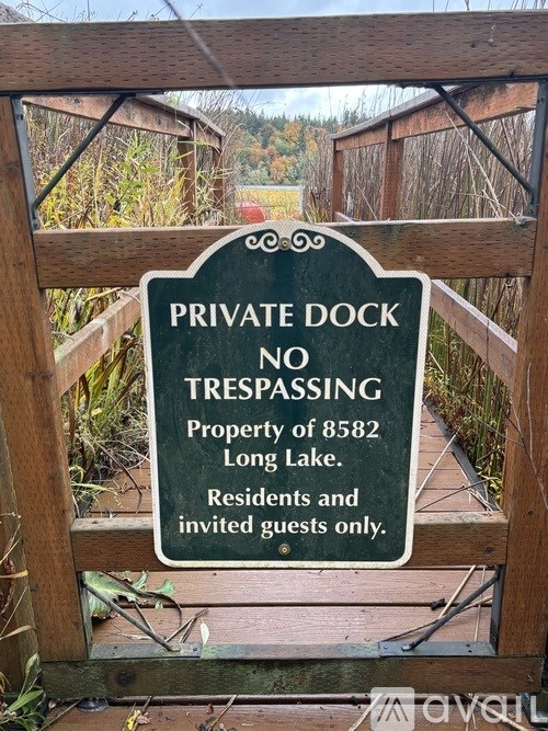 A sign on a gate that says Private Dock No Trespassing.