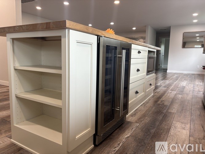 A kitchen with a white fridge and a wooden top.