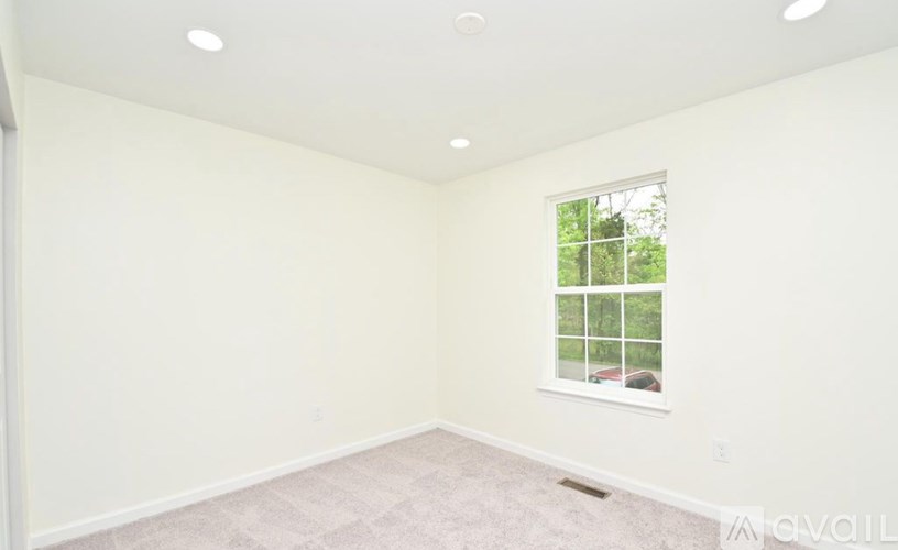 A room with a window and a car visible outside.