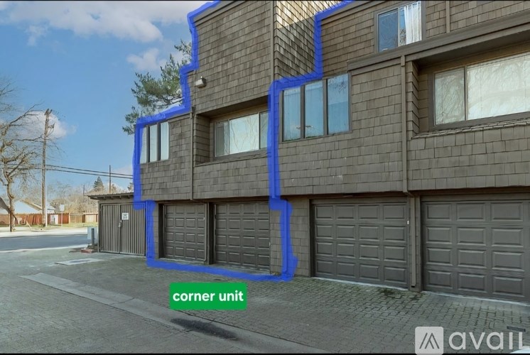 A corner unit of a building is highlighted in blue.