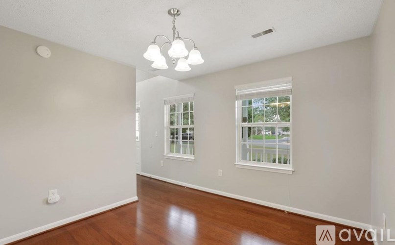 A room with a window and a chandelier.