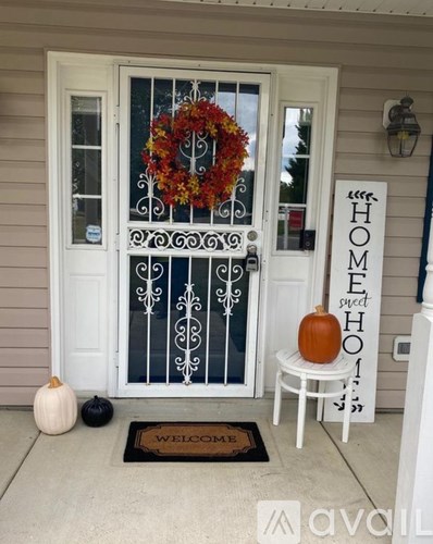 A white door with a glass panel and a wreath on it.
