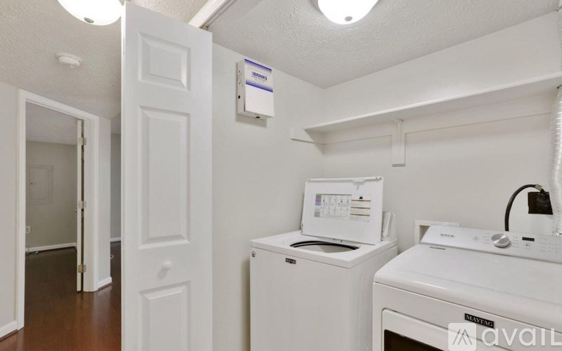 A small laundry room with a washer and dryer.