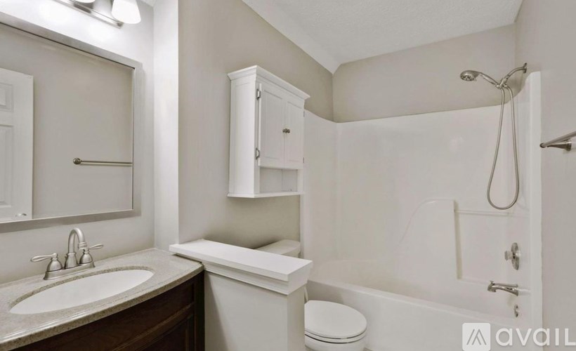 A white bathroom with a sink, toilet, and bathtub.