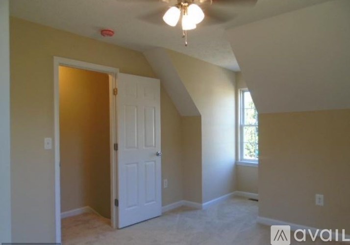 A room with a white door and a window.
