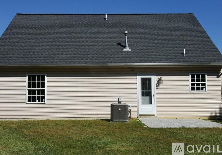 A house with a grey roof and a white door.