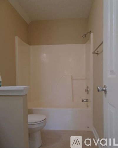 A bathroom with a toilet, tub, and shower.