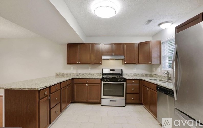 A kitchen with brown cabinets and a white countertop.