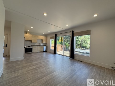 A spacious kitchen with a view of the backyard through the sliding glass doors.