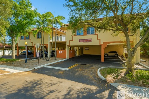 A building with a red and white sign that says "Residential" is surrounded by trees.