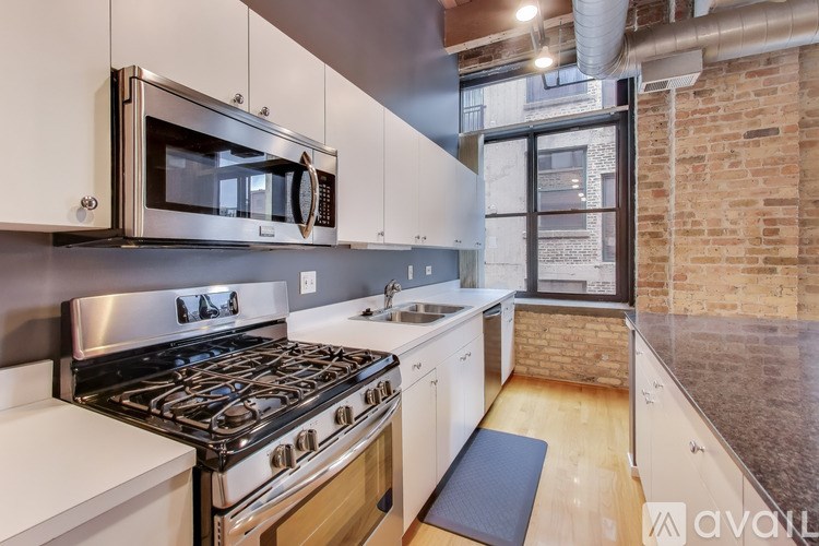 A kitchen with a stove top oven and a microwave above it.