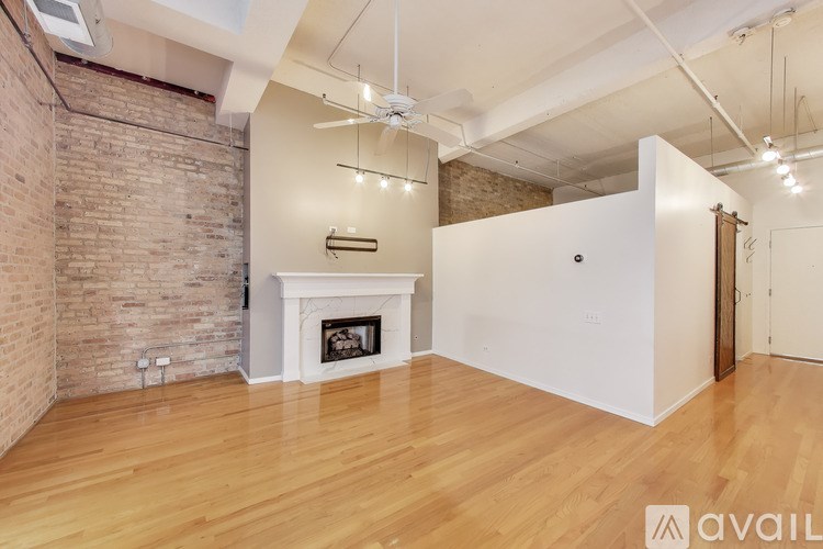 A room with a fireplace and wooden floors.