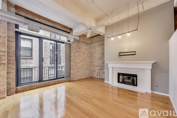 A room with a fireplace and a large window.