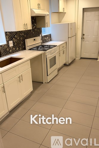 A kitchen with white appliances and cabinets.